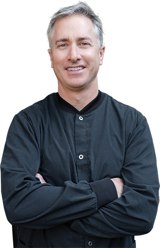 Dr Eric Batterton, DDS in black shirt with arms crossed