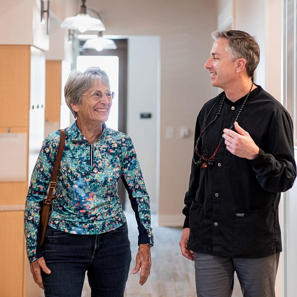 Dr. Batterton and smiling with patient after teeth whitening procedure